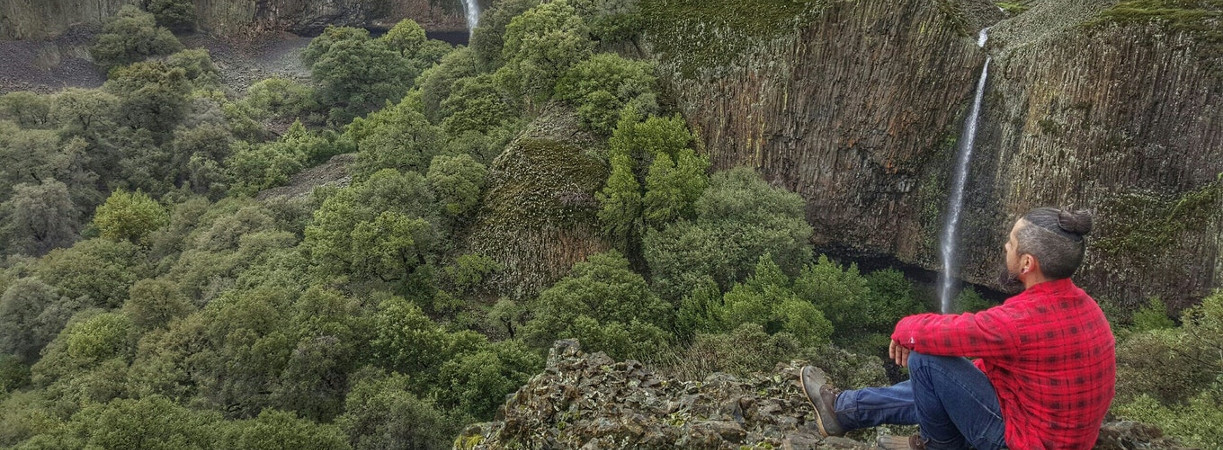 hiker at overlook with waterfalls